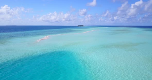 Luxury aerial clean view of a sunshine white sandy paradise beach and blue ocean background in 4K