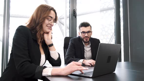 Collegues Working with Laptop at Modern Office