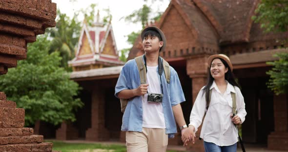 Couple hand together while visiting at ancient temple