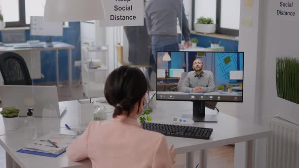 Freelancer Sitting at Desk Table in New Normal Company Office