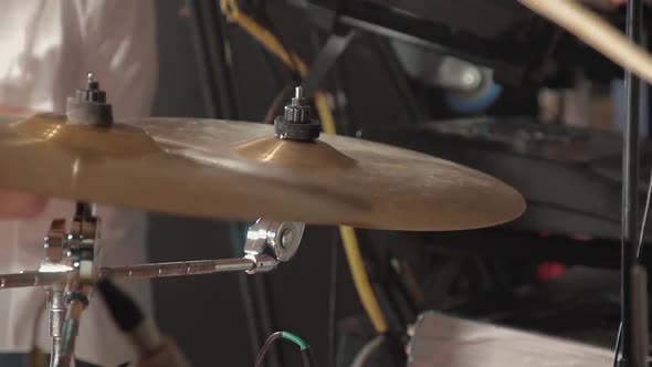 Drummer Plays Percussion Instruments at a Concert As Part of a Musical Group