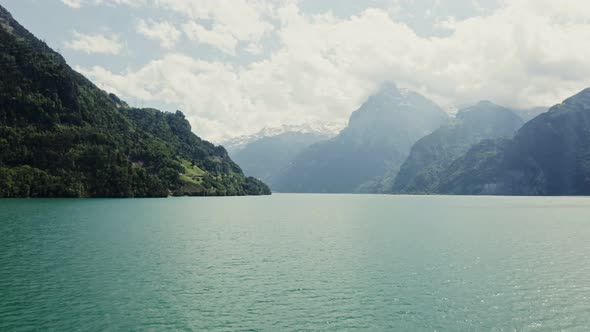 Scenic Drone Footage of a Lake View at the Foot of the Alps in Switzerland