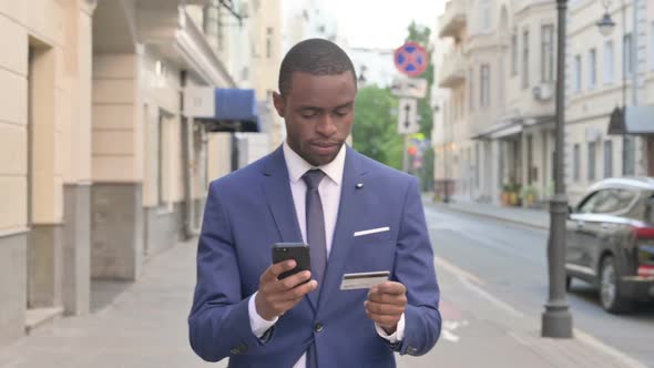 Walking African Businessman Shopping Online