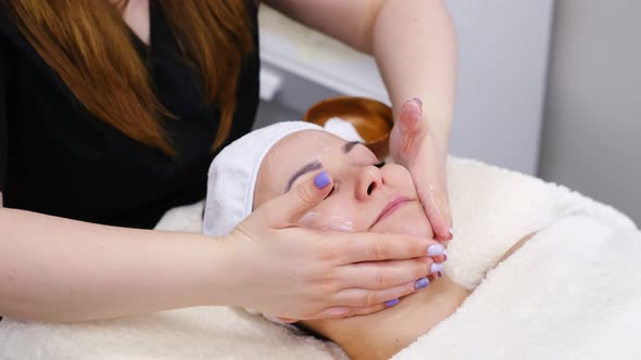 Woman Gets Face Massage in Spa Salon