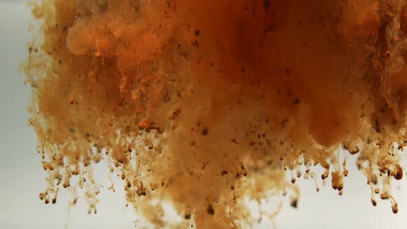 Macro Shot of Coffee Powder Being Poured Into Hot Water