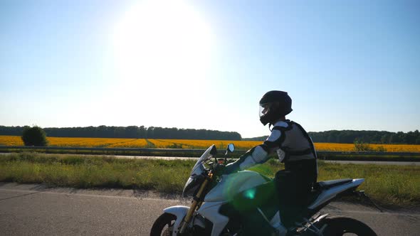 Man in Helmet Riding Fast on Powerful Sport Motorbike at Highway. Motorcyclist Racing His Motorcycle