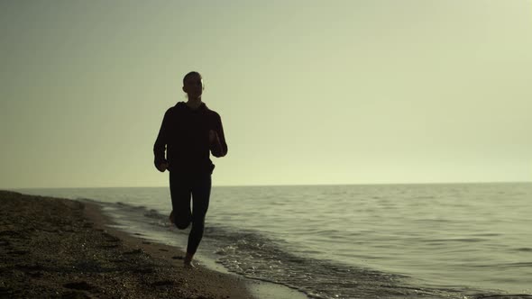 Silhouette Woman Running Beach at Sunset