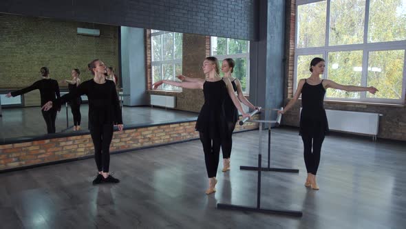 Young Ballerinas Practicing at Ballet Barre