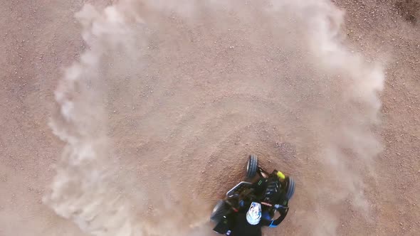 Riding Quad Bike. Man in Protective Equipment and Helmet, Drifting on His ATV. Slow Motion Aerial