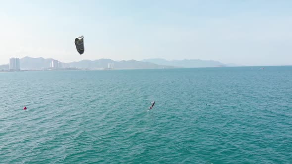 Aerial View of the City Beach and Active People Practicing Kite Surfing and Windsurfing. Kitesurfing