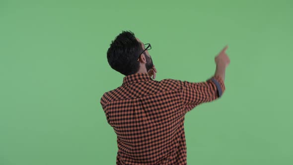 Rear View of Young Bearded Persian Hipster Man Pointing Finger