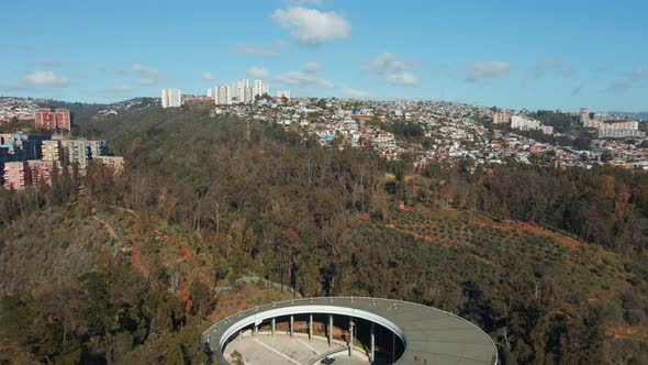 Aerial dolly out of Quinta Vergara Amphitheater and Park surrounded by autumnal trees, Viña del Mar