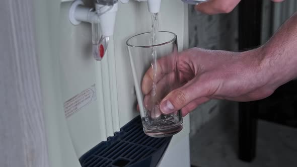 Water Cooler Clear Water is Pouring Into Glass From the Water Dispenser