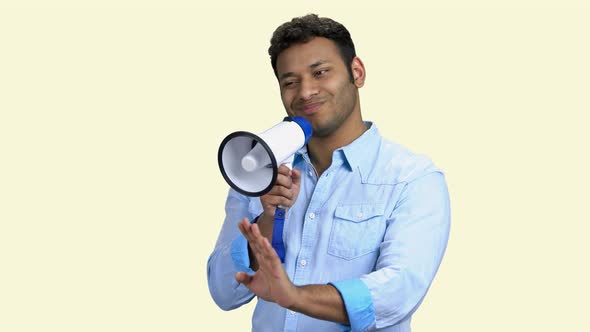 Young Man Using Megaphone on White Background