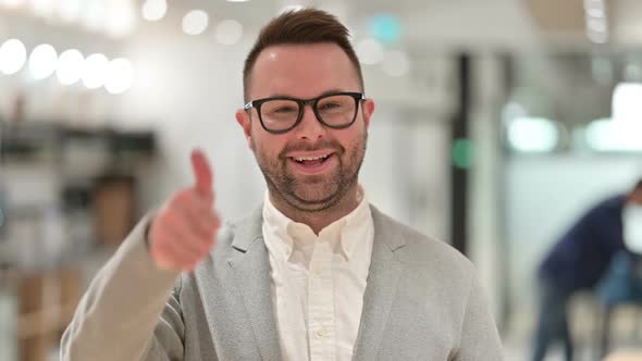 Positive Creative Man Doing Thumbs Up