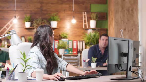 Female and Male Colleagues Talking Over a New Project