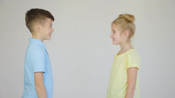 Profile View of Two Children Girl and Boy Talking Discuss