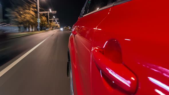 Drivelapse From Side of Car Moving on a Night Avenue in City Timelapse Hyperlapse