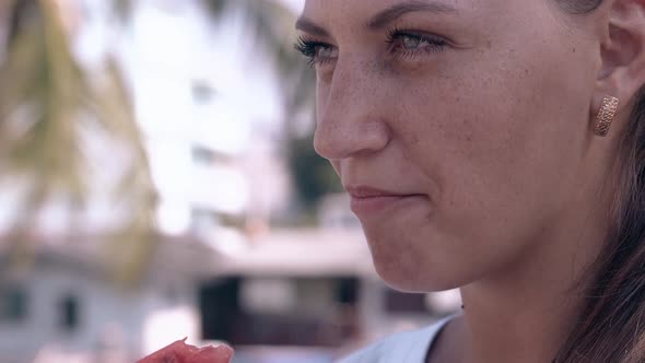 Wonderful Lady with Golden Earrings Eats Watermelon Slice