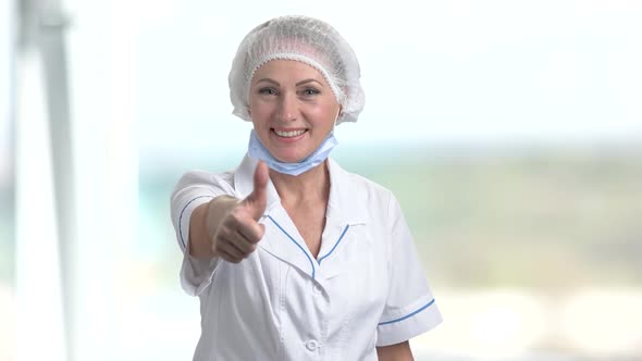 Smiling Female Doctor Gesturing Thumb Up