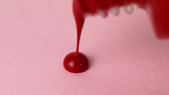 Woman makes brush strokes for nail polish. Cosmetics for covering nails. Beauty and care.