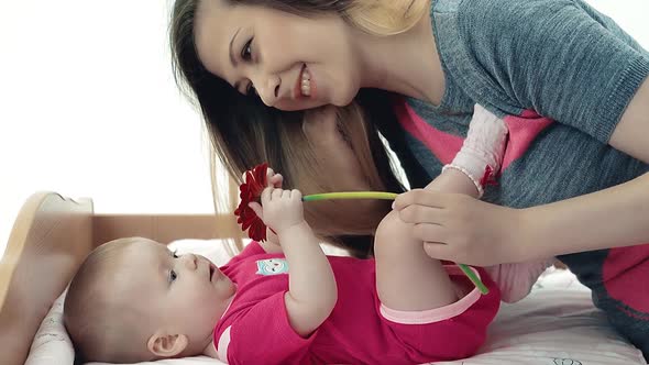 Young Mother Playing with Her Baby