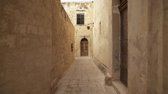 Narrow Street with Old Wooden Doors and Heavy Lantern Hanging on Building Wall