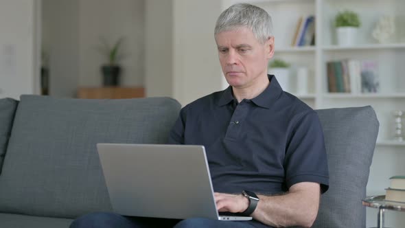 Exhausted Middle Aged Businessman Having Back Pain on Sofa