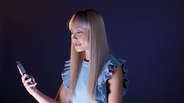 Smiling woman reading smartphone message