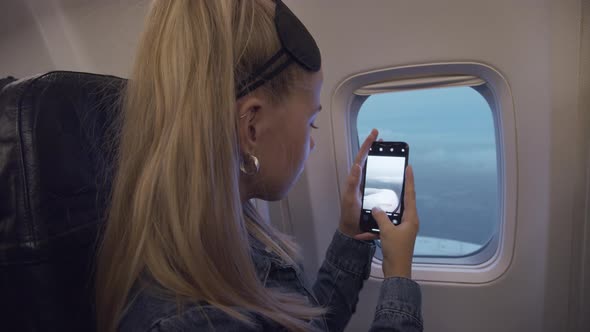 Teenage Girl Filming View From Airplane