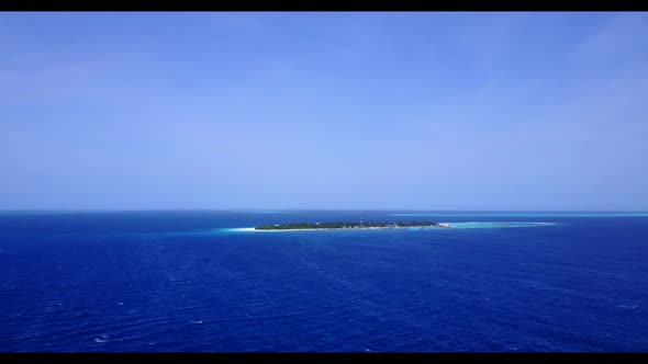 Aerial drone shot panorama of tranquil island beach lifestyle by blue water and white sand backgroun