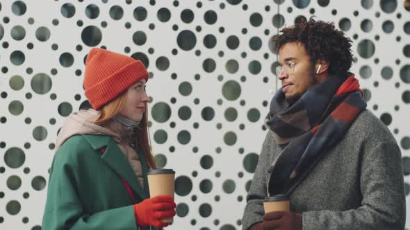 Portrait of Multiethnic Man and Woman Talking over Coffee Outdoor