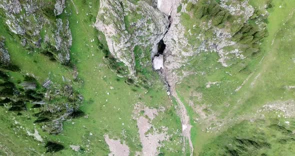 Top View of Steep Mountain Cliffs and an Ice Cave