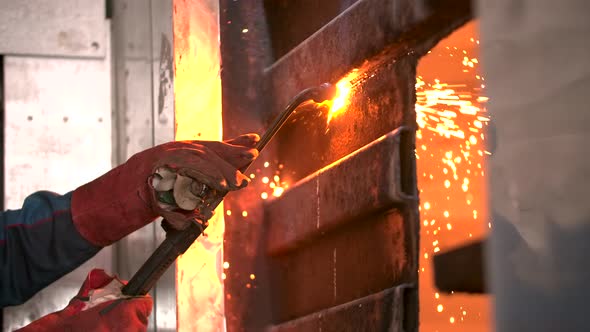 A Skilled Man Cutting a Metal Sheet with a Gas Welding Machine