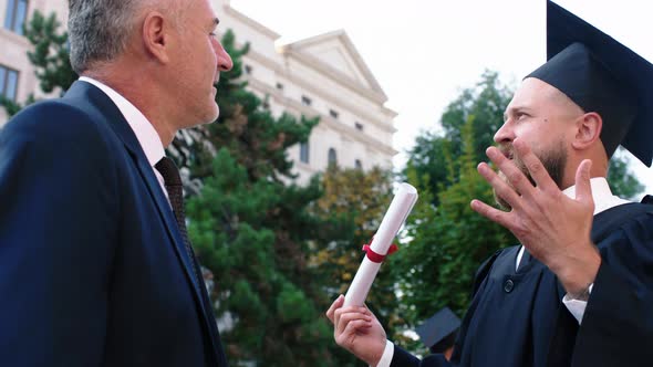 Good Looking Man Graduate Have a Conversation with