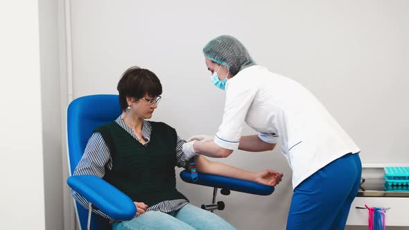 Applying a Tourniquet on the Arm to Take Blood