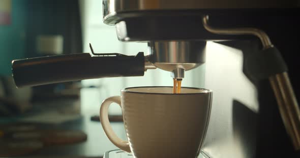 Pouring Coffee Stream From Machine in Cup