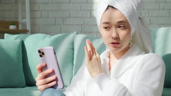 Girl in Bathrobe and with Bath a Towel on Her Head is Making a Selfie