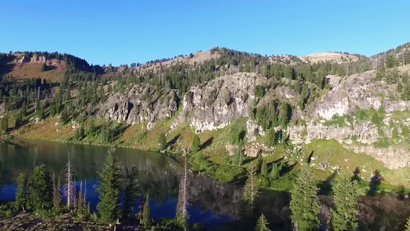 Slow zoom of a stunning mountain lake with the mountains reflecting on the water