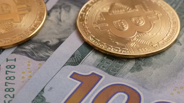 Close-up bitcoins and American dollars rotate. 100 dollar bills,