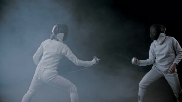 Fencing Training - Two Young Women Having a Duel in the Smoky Studio - Poking in Each Other