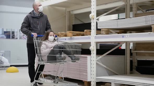 A Man and Child in a Medical Mask in Market with a Timelapse Grocery Cart. Protection From the