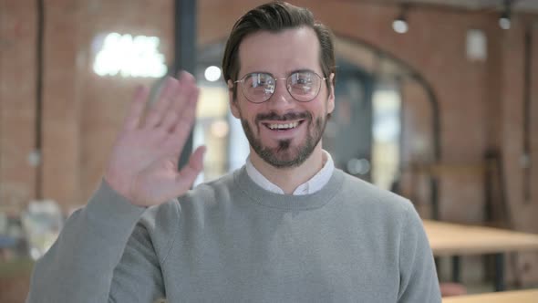 Portrait of Young Man Waving Welcoming