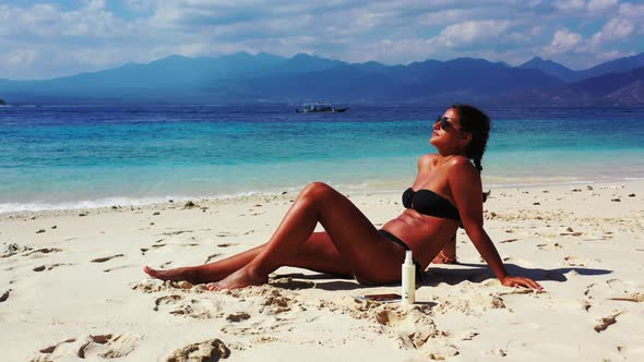 Sexy beauty models on photoshoot having fun on the beach on paradise white sand and blue background 