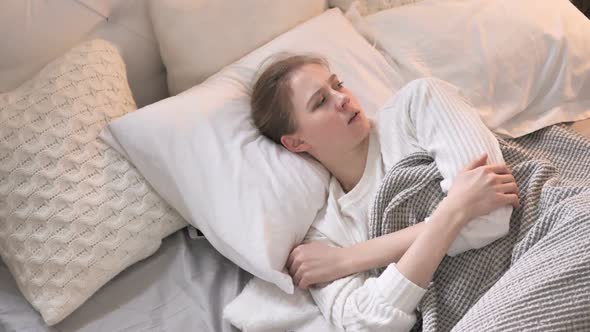 Top View of Young Girl Waking Up in Shock Nightmare