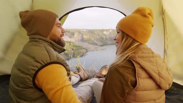 Couple Sitting in Tent and Enjoying Scenery
