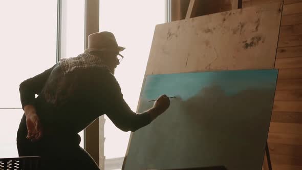 Male Artist Is Working on a Painting.