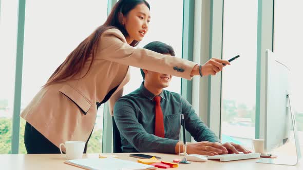 Two Business People Talk Project Strategy at Office