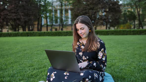 Beautiful Woman Using Laptop in the Outdoor Park.