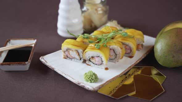 Close-up, mango sushi set on white clay plate